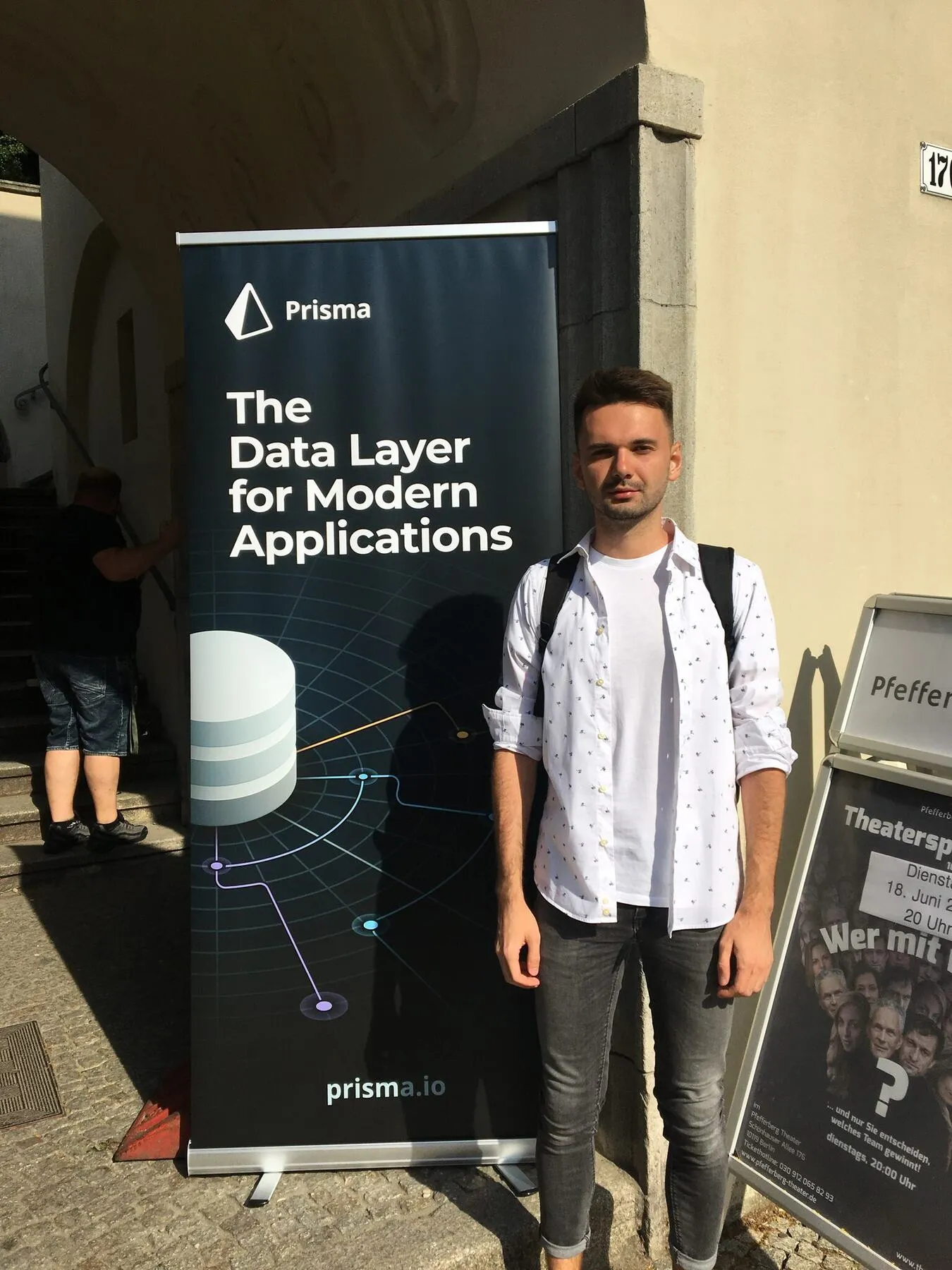 In front of the Prisma banner