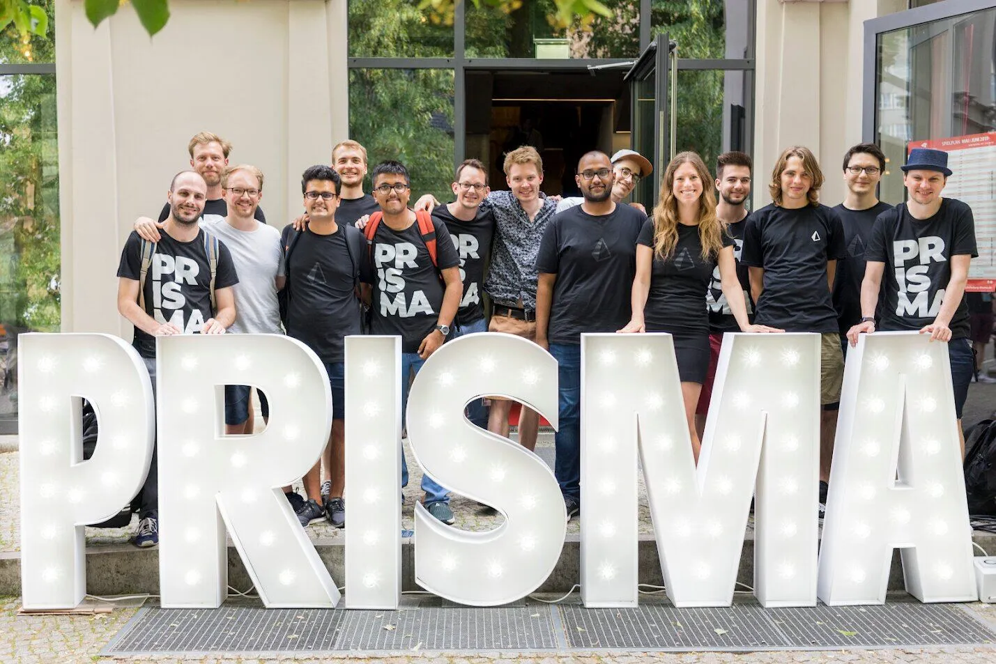 Prisma Day attendees behind the PRISMA letters