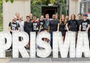 Prisma Day attendees behind the PRISMA letters